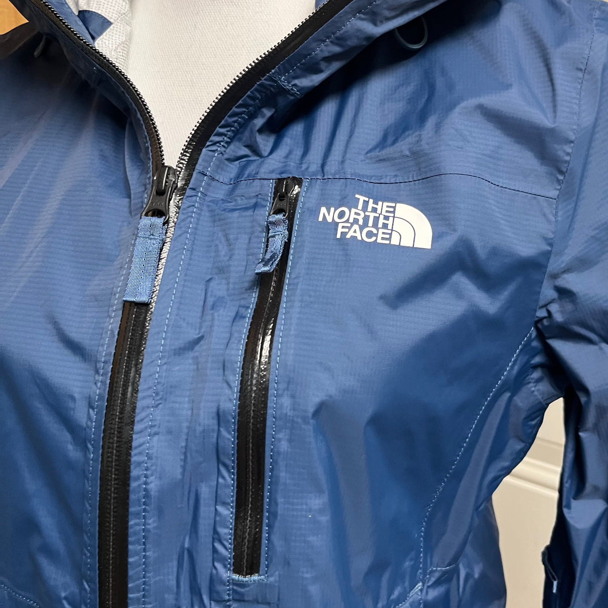 The North Face blue rain jacket, size S